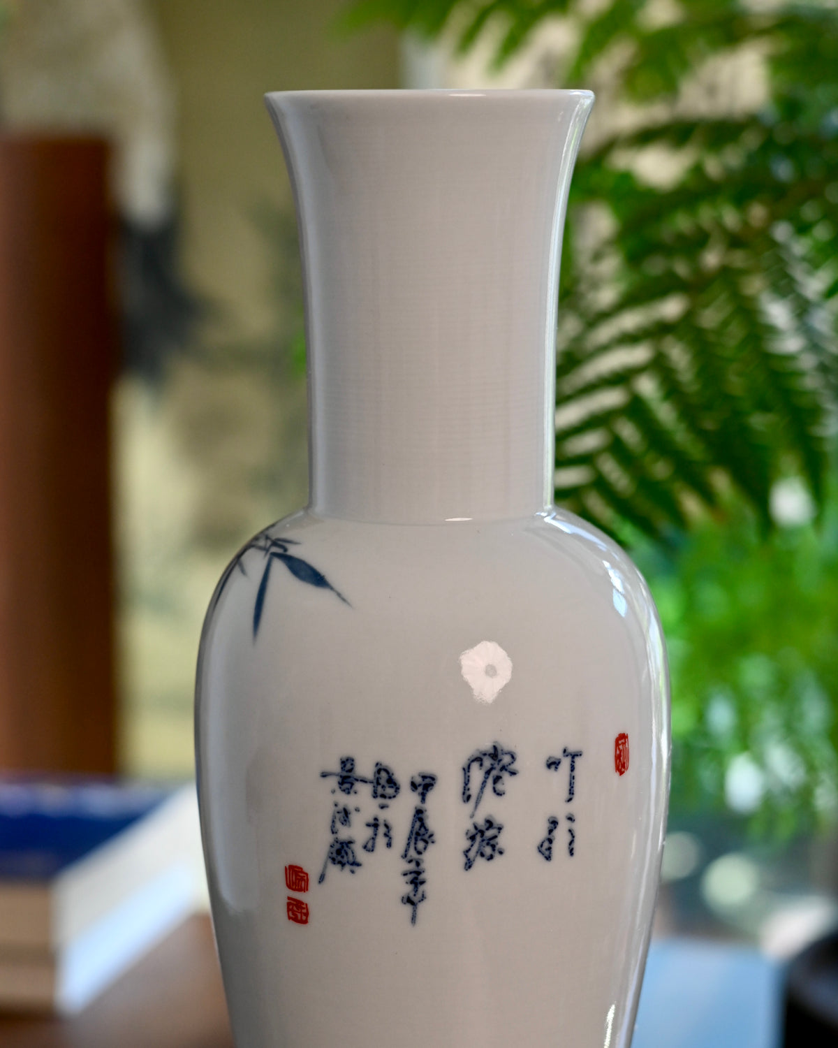 Glossy white porcelain base texture and cobalt blue floral brushwork detail
