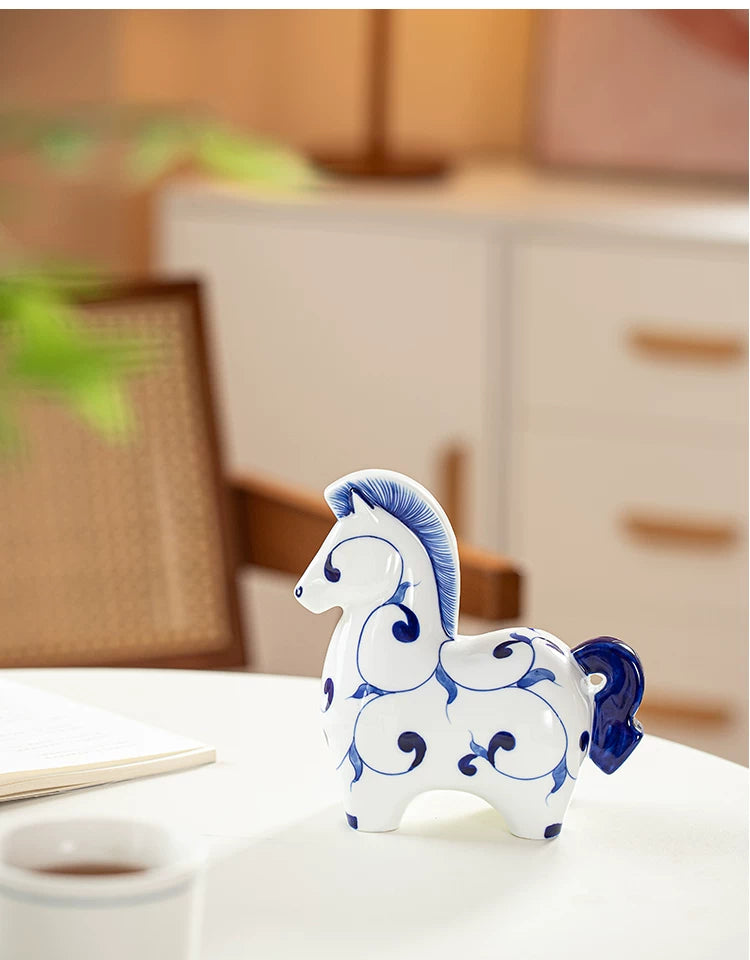 Decorative ceramic horse figurine with hand-drawn blue swirl motifs, smooth glaze finish, elegant table accent for tea room styling