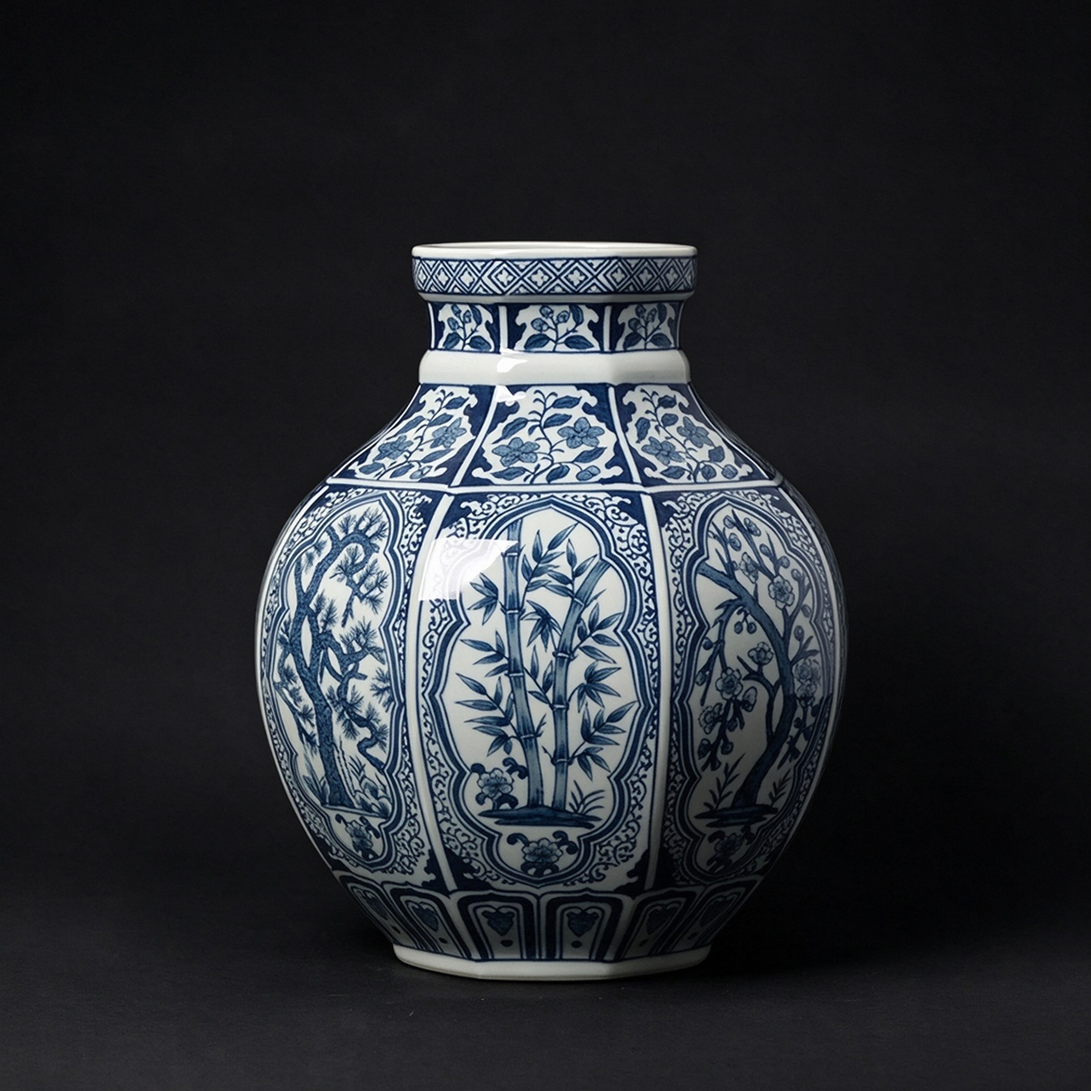 Blue and white porcelain vase with intricate botanical panel motifs
