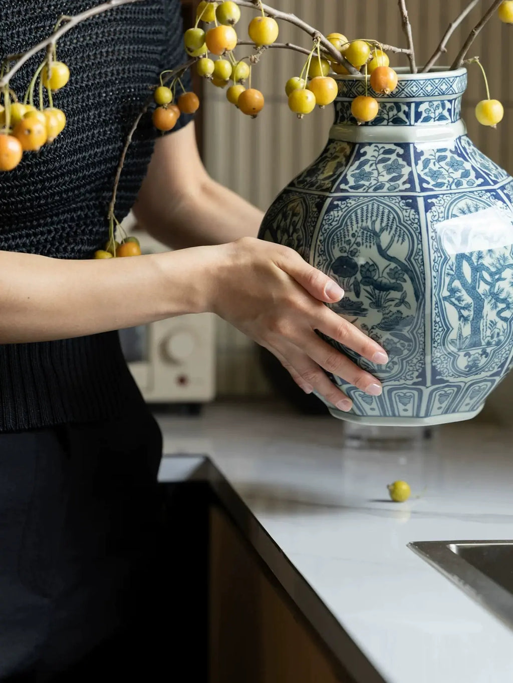 Blue and white Chinoiserie-style vase with intricate floral and botanical decoration