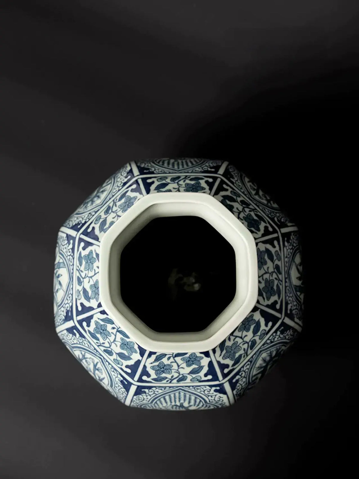 Blue and white Oriental vase featuring intricate floral and foliage motifs