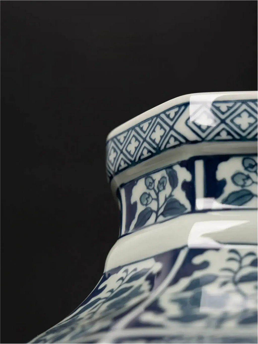 Blue and white porcelain vase with framed botanical scenes and geometric motifs