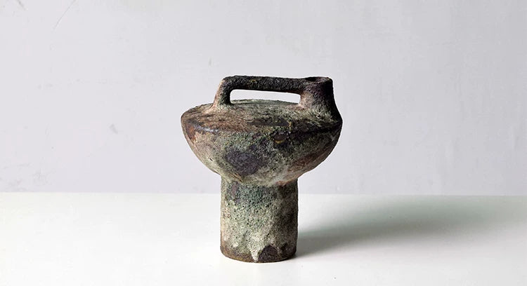 Brown speckled rough pottery vase with handle, aged textured ceramic vessel for table decoration