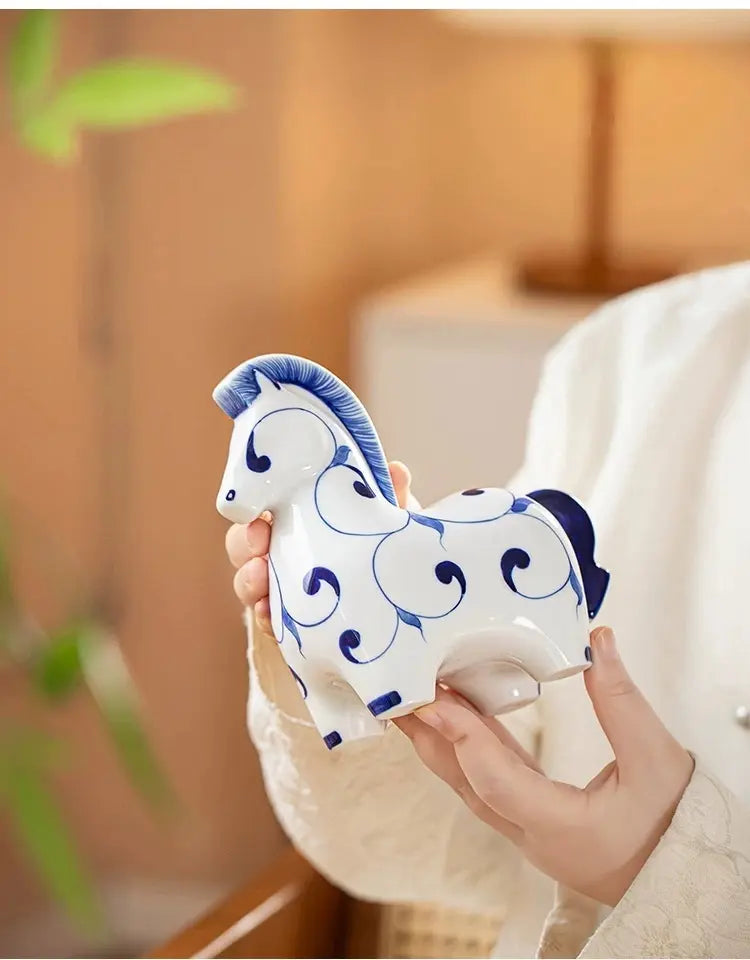 Chubby rounded ceramic horse sculpture with hand-painted swirling blue patterns, glossy glazed shelf ornament symbolizing vitality and success