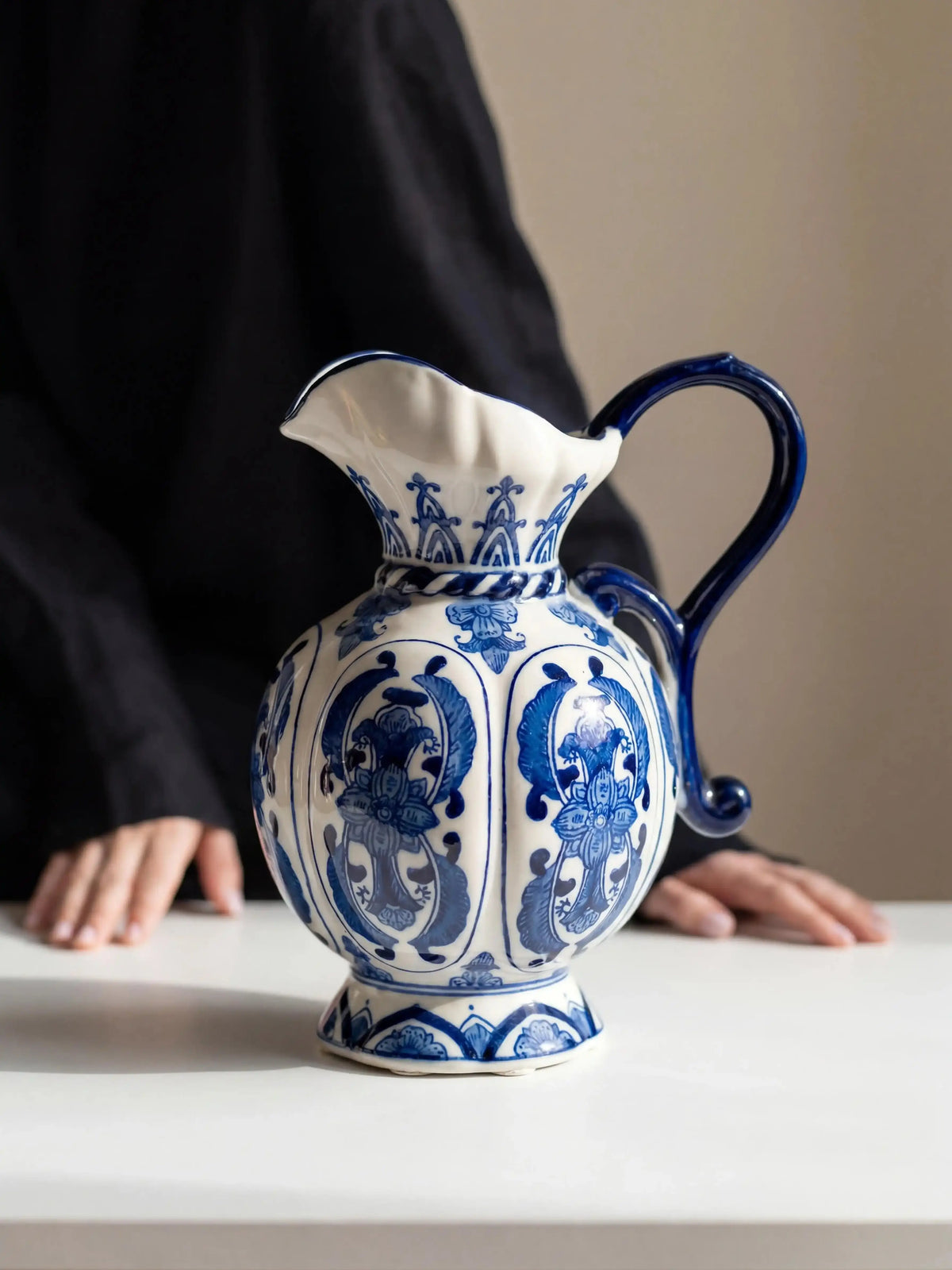 Handcrafted blue and white jug-shaped porcelain vase with floral motifs, artistic decor piece for tea room and meditation space