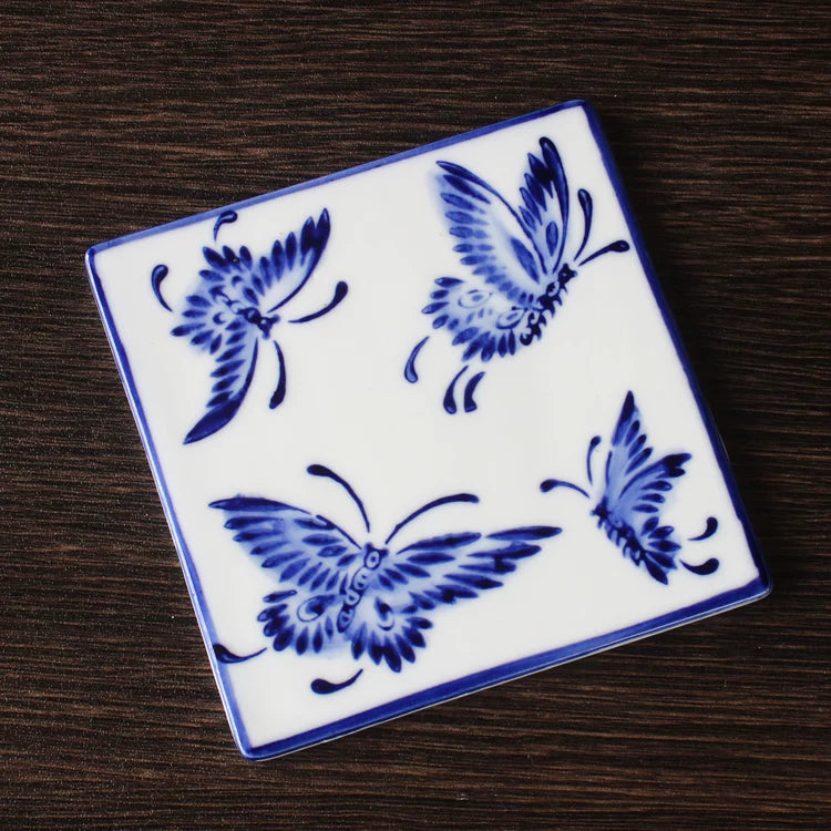 Decorative porcelain square mat with traditional Chinese floral and vine motifs in underglaze blue

