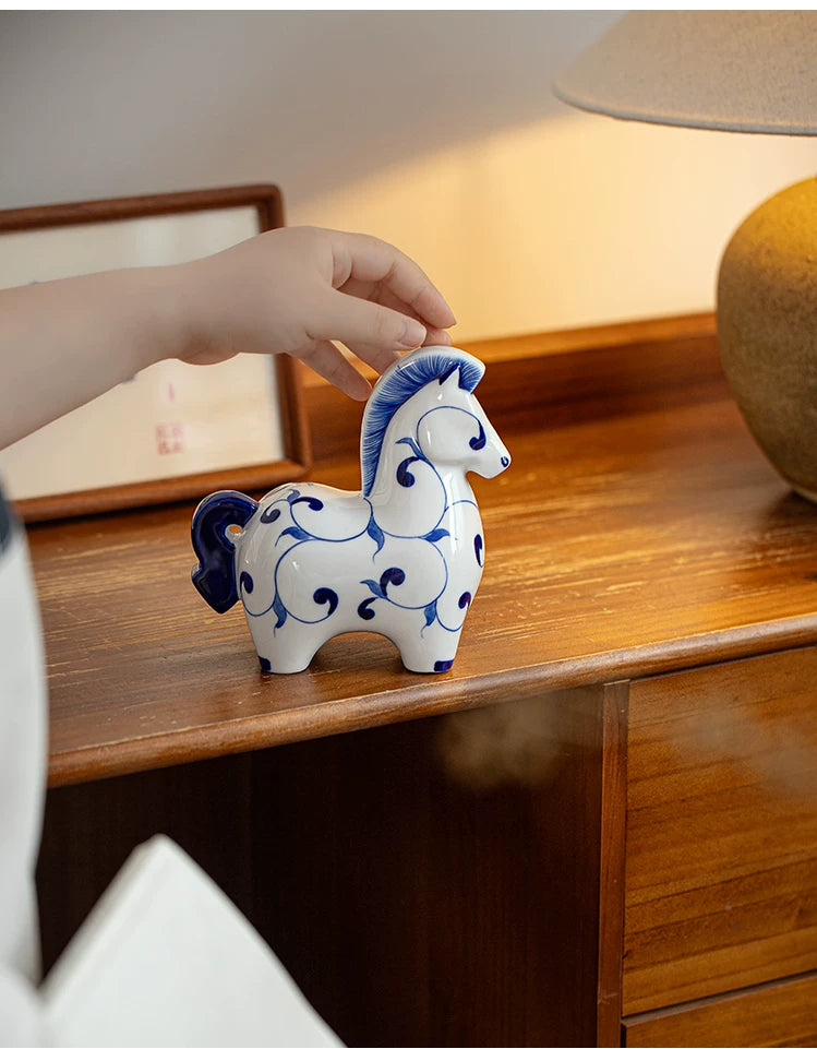 Glossy white ceramic pony sculpture decorated with deep blue hand-painted patterns, charming shelf decoration for living room