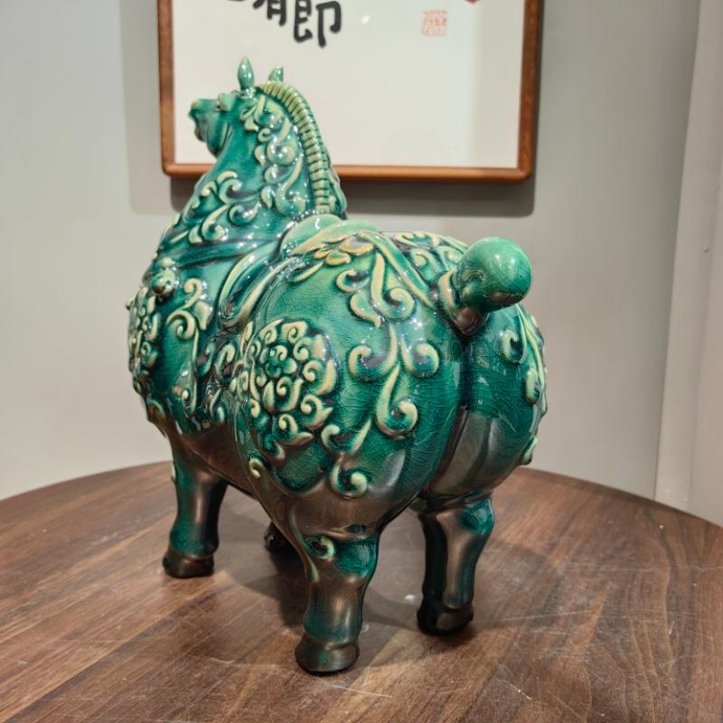 Tang horse ornament showcasing robust silhouette and floral reliefs
