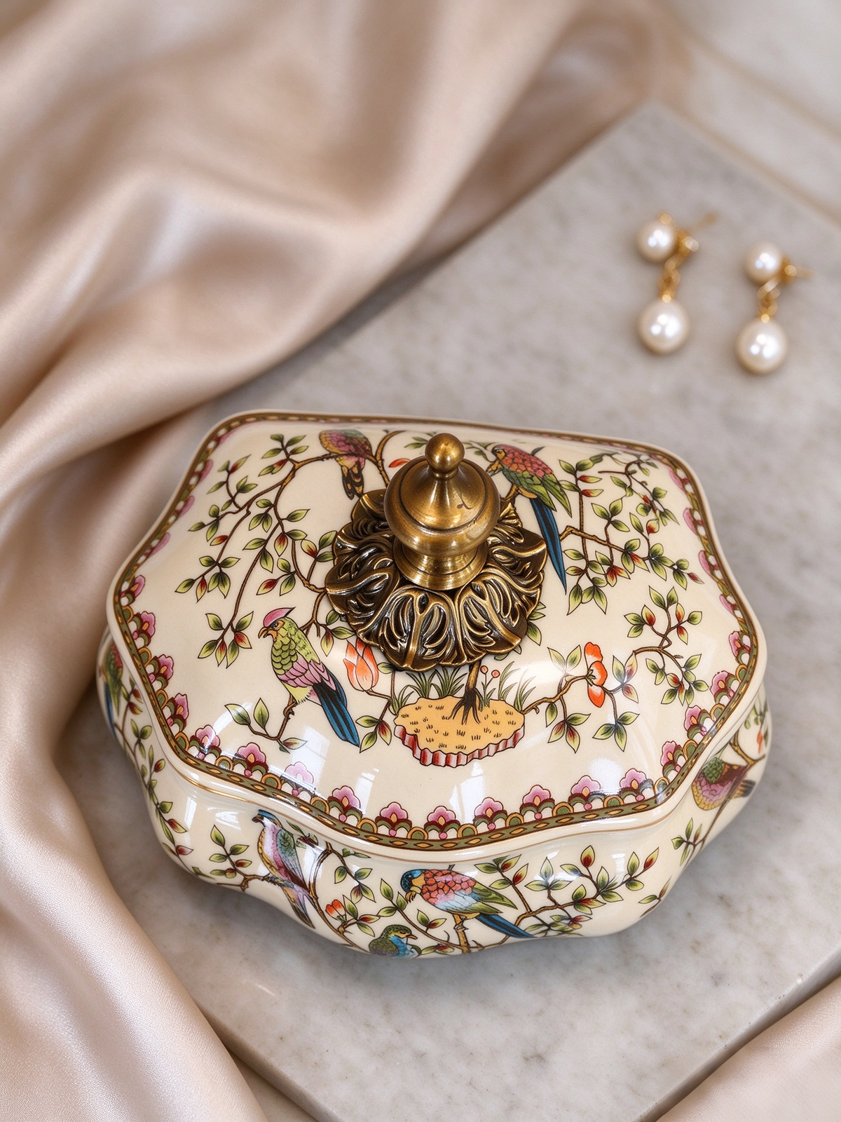 Ceramic storage box fitted with ornate vintage metal finial, hand painted tropical birds and flower branches