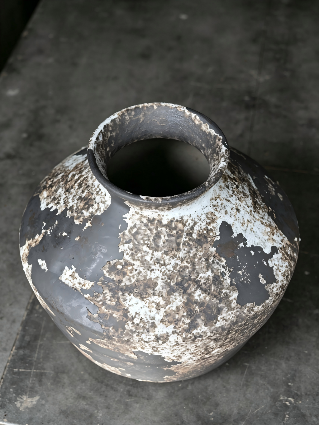 Hand-thrown distressed stoneware vessel, overhead shot showing vase mouth, industrial rustic home decor