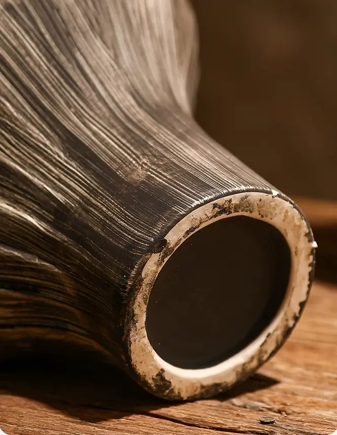 Ribbed organic ceramic vase with flowing sculptural texture and a tactile handmade surface