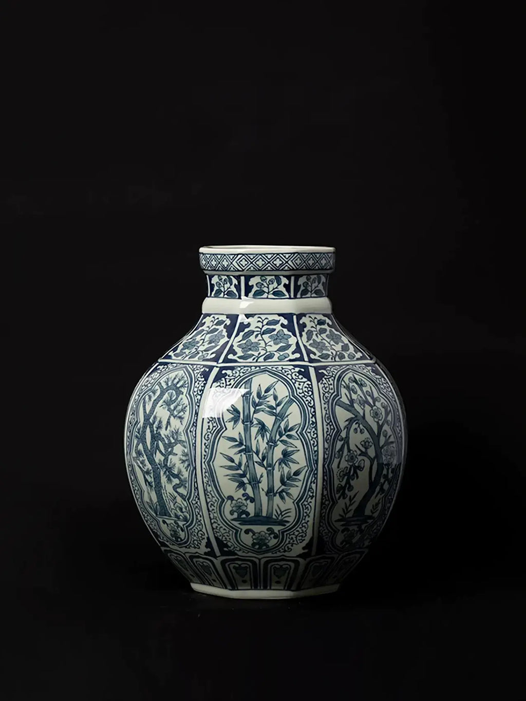 Traditional-inspired porcelain vase featuring detailed blue botanical artwork