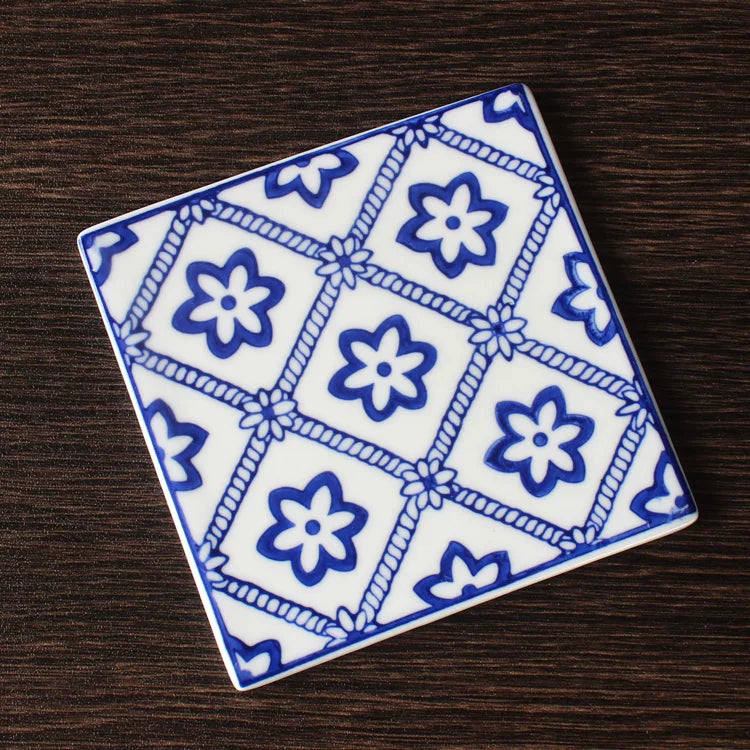 Underglaze blue botanical tile with deep cobalt pigment sunk into transparent glaze